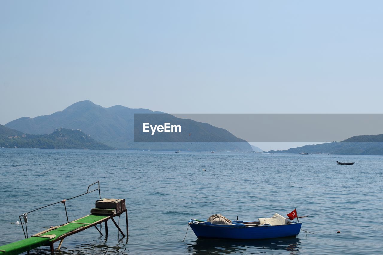 Row boat in the mediterranean sea against clear sky