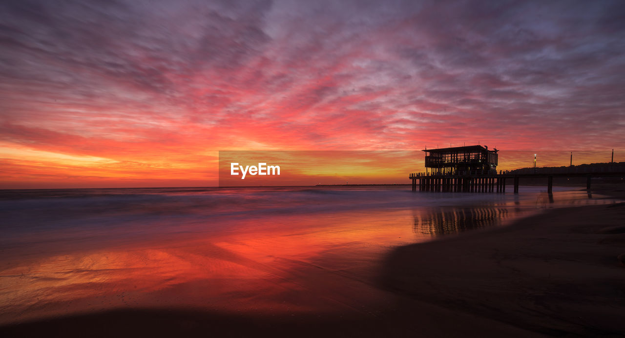 Scenic view of sea against orange sky