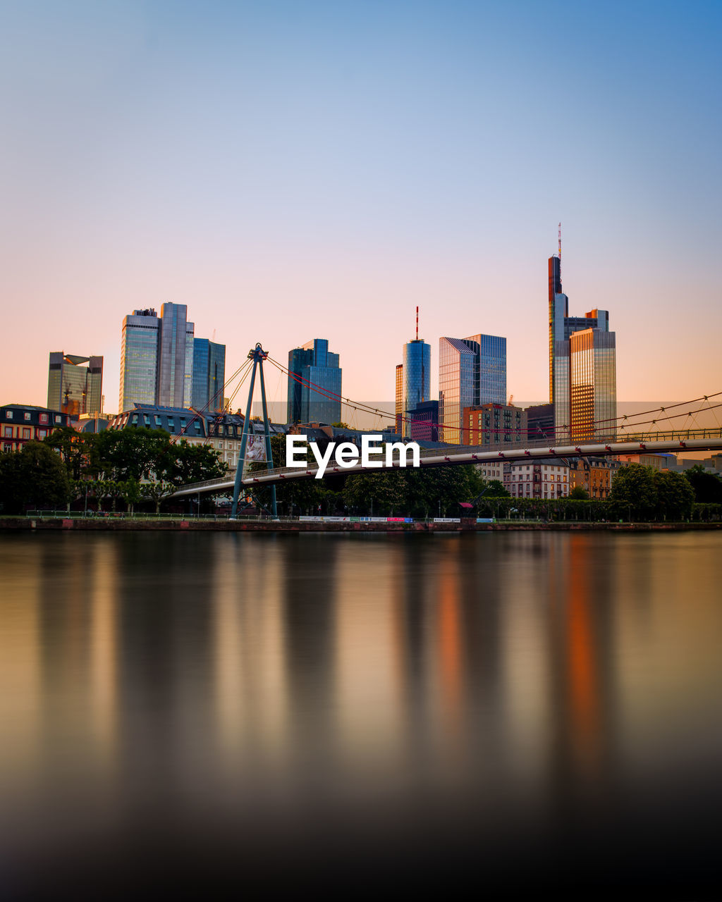 River by buildings against clear sky in city