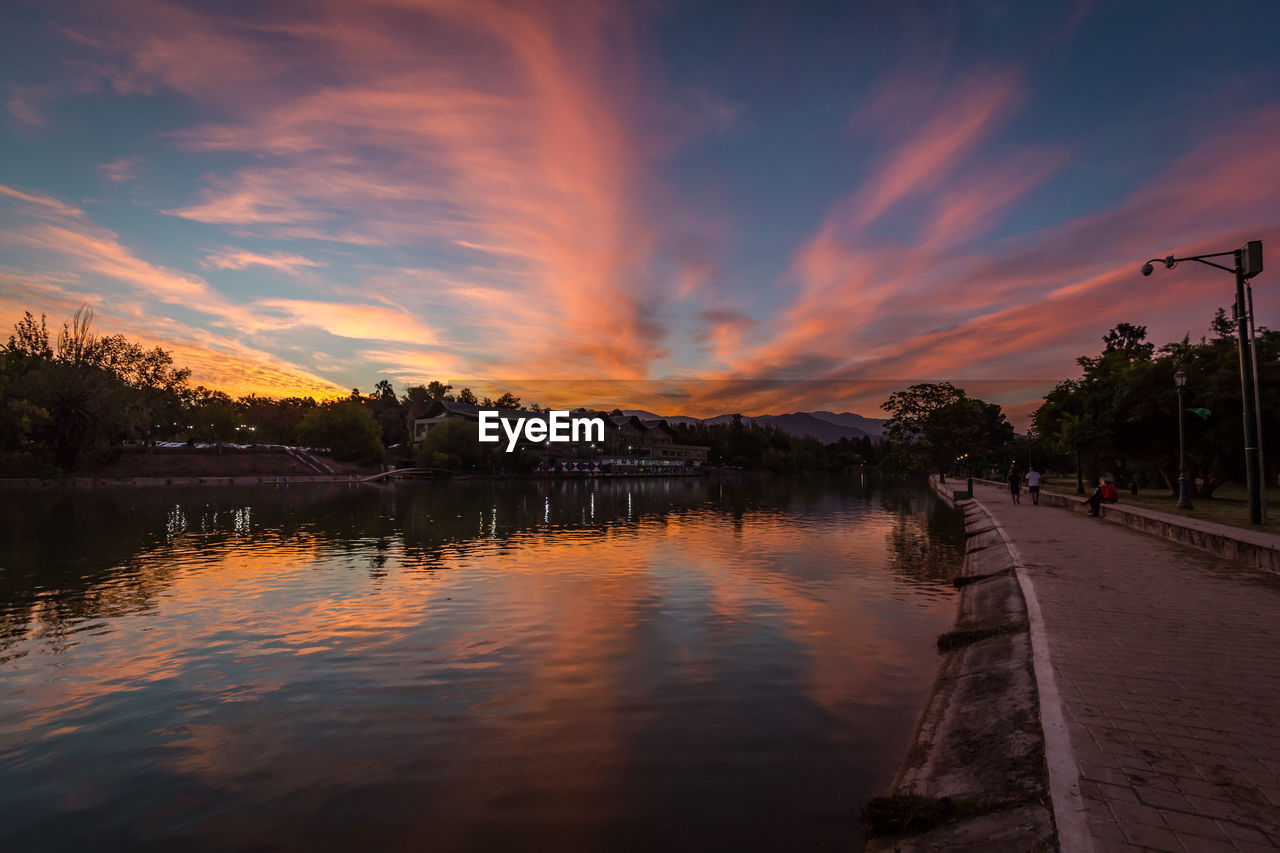 SCENIC VIEW OF LAKE AGAINST ORANGE SKY DURING SUNSET