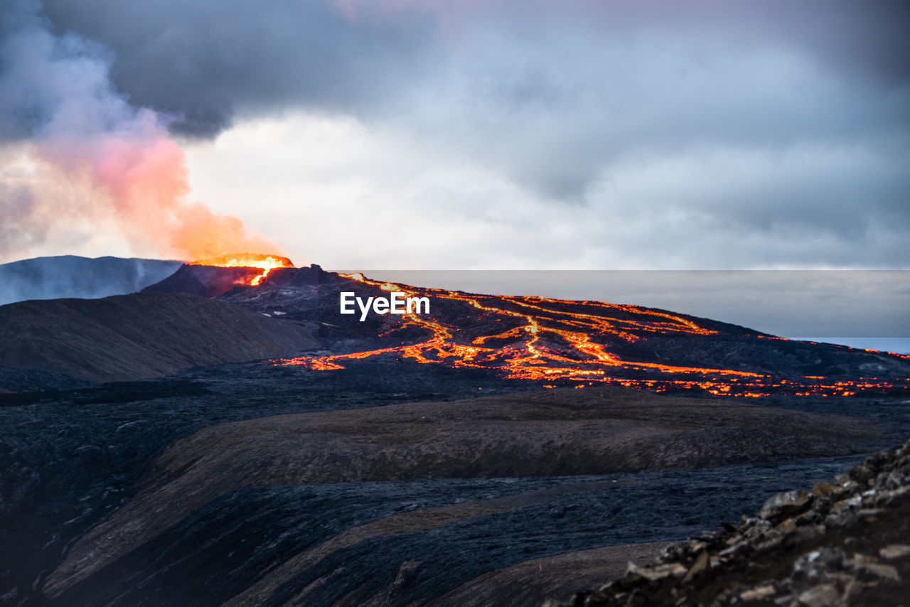 volcano, mountain, lava, geology, landscape, environment, beauty in nature, power in nature, erupting, land, nature, cloud, active volcano, volcanic landscape, sky, scenics - nature, non-urban scene, no people, smoke, travel destinations, sign, outdoors, heat, warning sign, island, extreme terrain, physical geography, volcanic rock, accidents and disasters, travel, communication, sunrise, volcanic crater, volcanic activity, ash, rock, natural phenomenon, motion, water