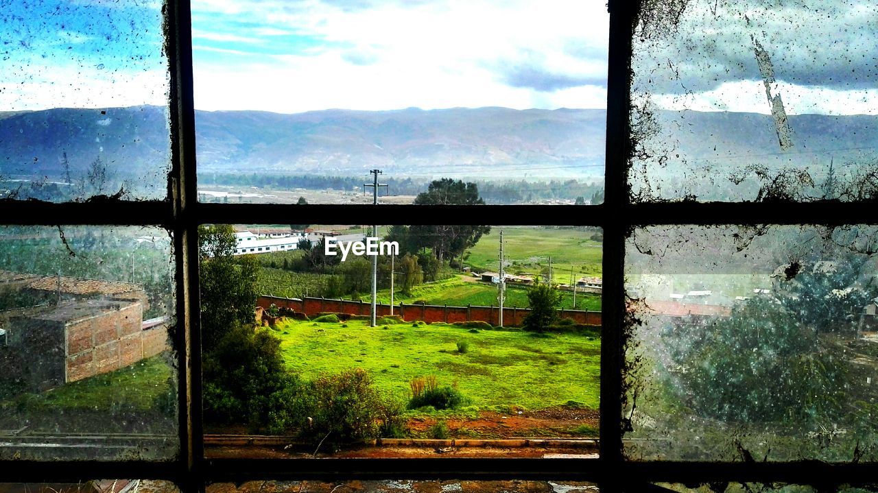 Scenic view of landscape seen through window