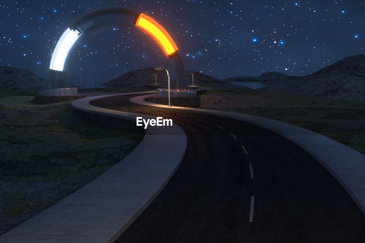 Light trails on road against sky at night