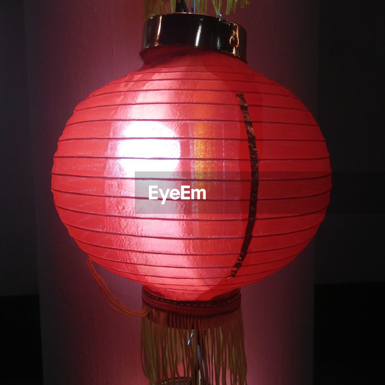 LOW ANGLE VIEW OF ILLUMINATED LANTERN HANGING AT NIGHT