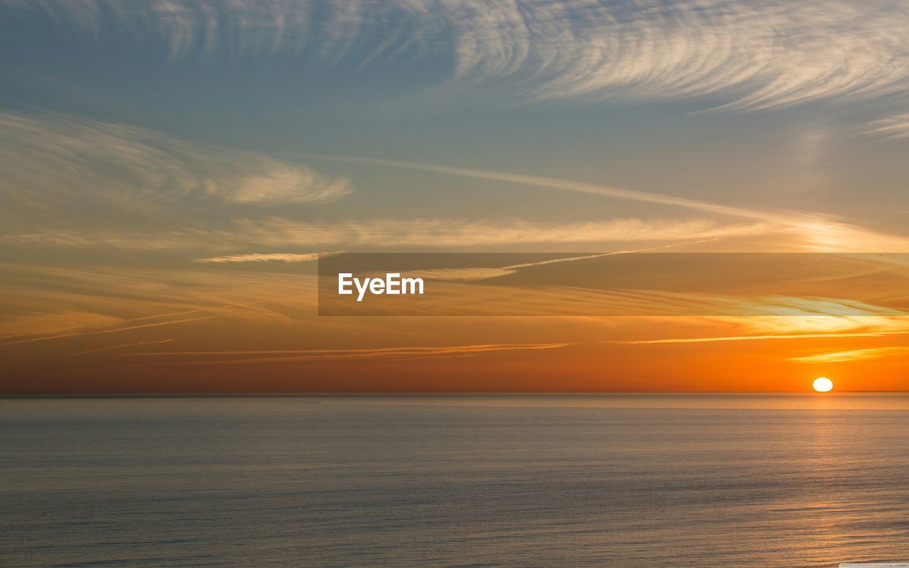 Scenic view of sea against sky at sunset