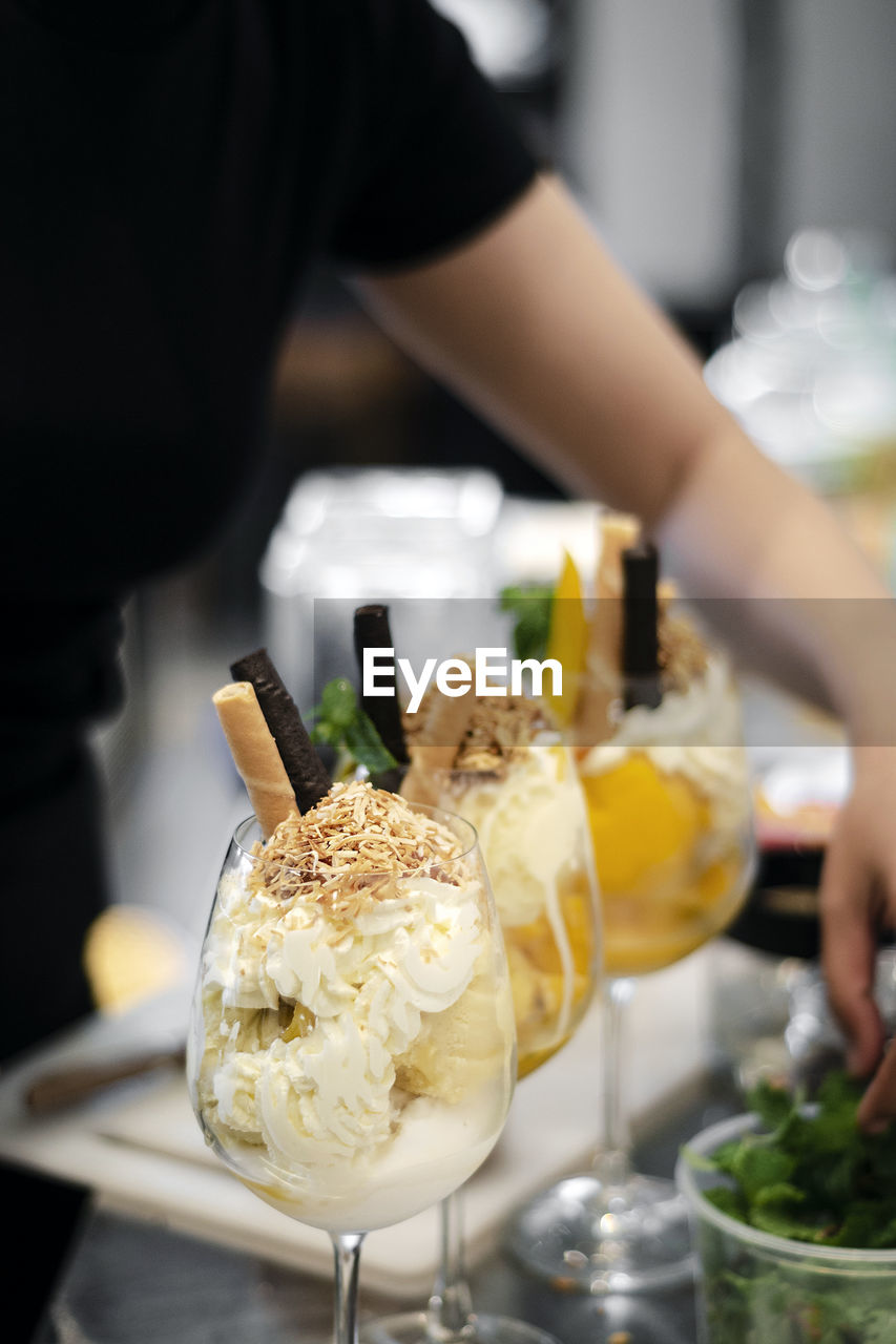 HIGH ANGLE VIEW OF ICE CREAM IN GLASS ON TABLE