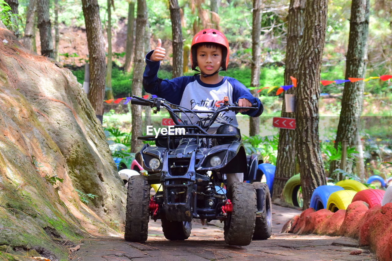 Portrait of boy riding motorcycle / atv