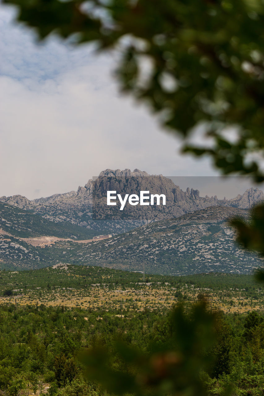 SCENIC VIEW OF LANDSCAPE AND MOUNTAINS AGAINST SKY