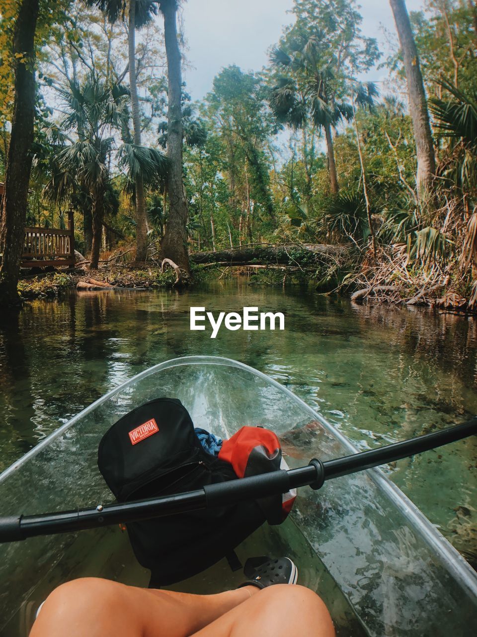 MAN SAILING ON BOAT IN RIVER