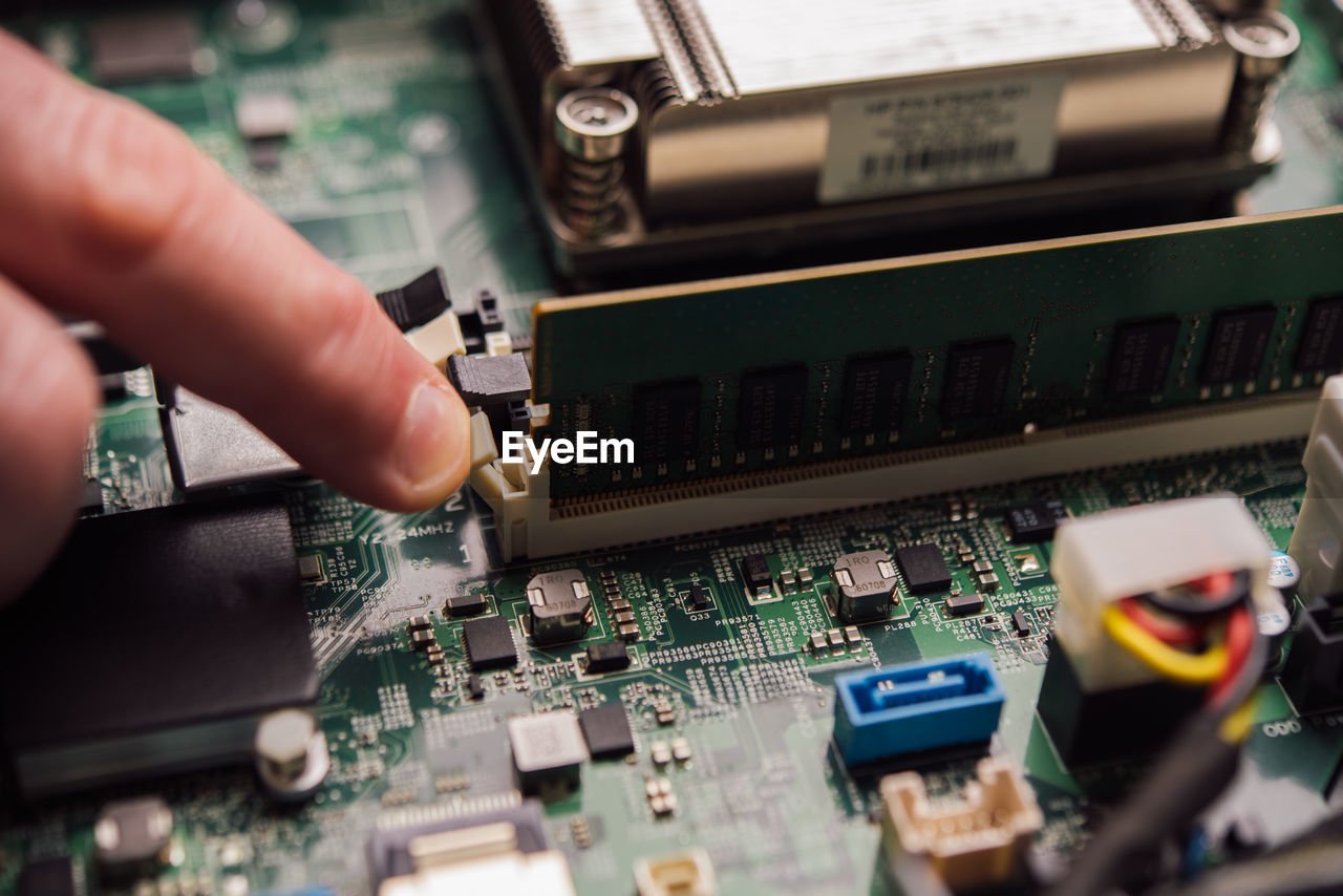 cropped hands of person holding circuit board