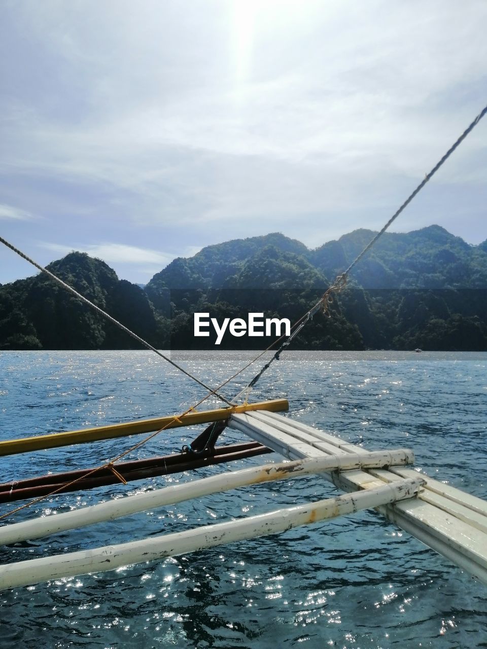 Sailboat in sea against sky