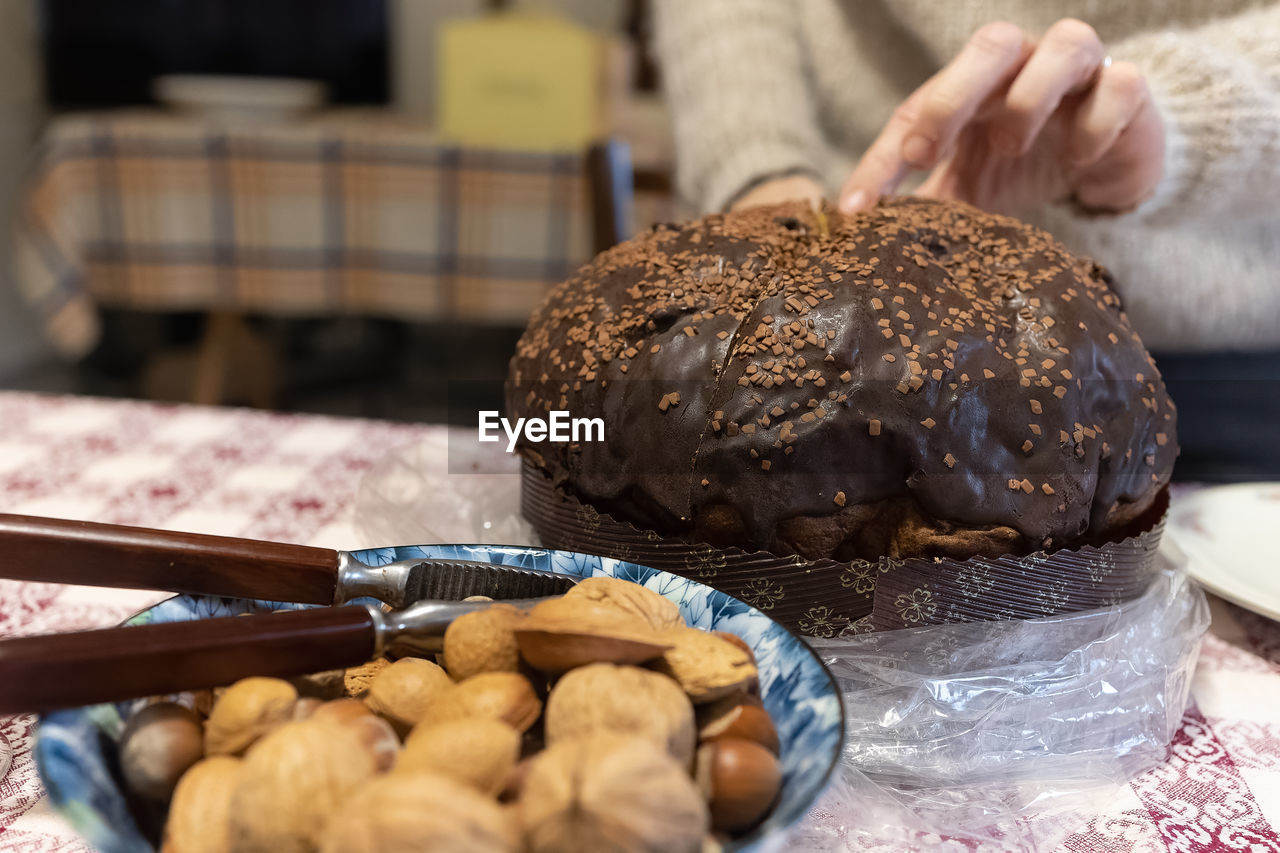 food, food and drink, freshness, baked, bread, dessert, hand, one person, fast food, healthy eating, indoors, produce, close-up, meal, table, breakfast, store, bakery, wellbeing, sweet food, focus on foreground, bun, selective focus