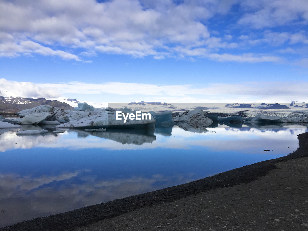 Scenic view of lake against sky during winter