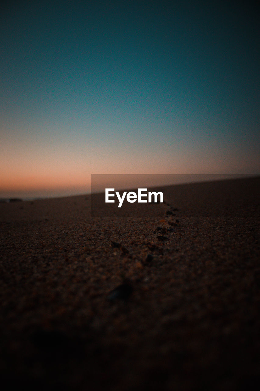 SCENIC VIEW OF BEACH AGAINST SKY DURING SUNSET