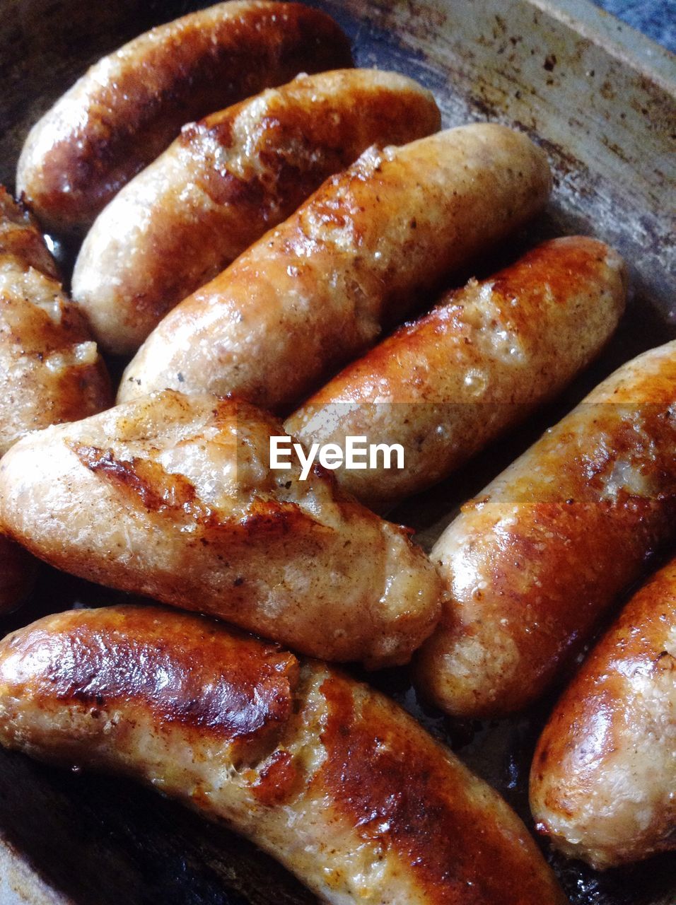 Close-up of sausages being cooked indoors
