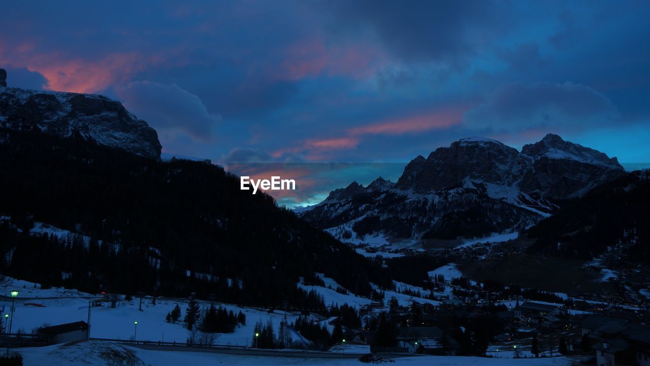 Scenic view of snowcapped mountains against sky during sunset