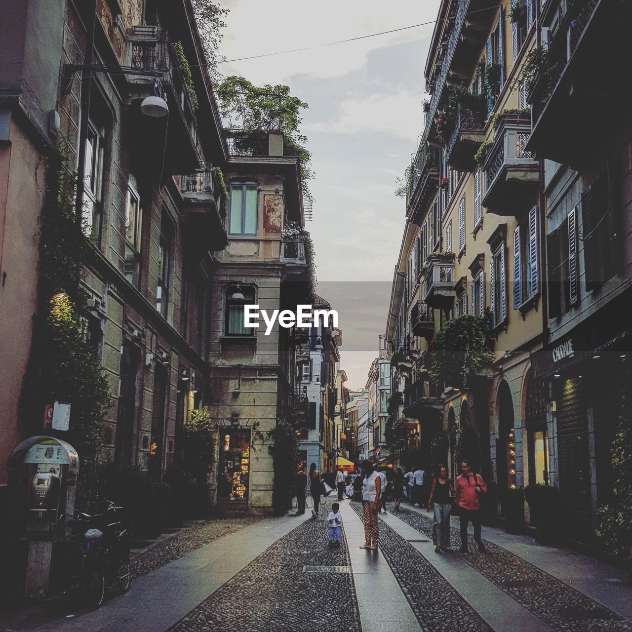 STREET AMIDST BUILDINGS AGAINST SKY