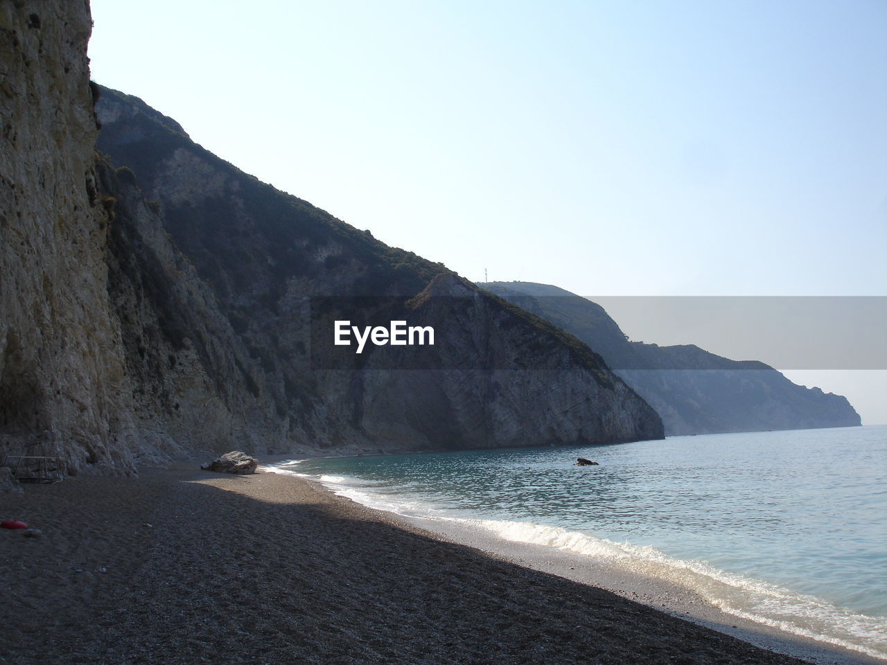 SCENIC VIEW OF SEA WITH MOUNTAINS IN BACKGROUND