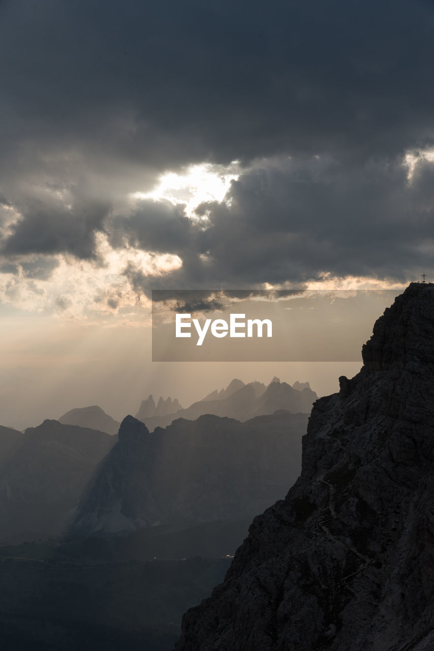 Scenic view of mountains against cloudy sky