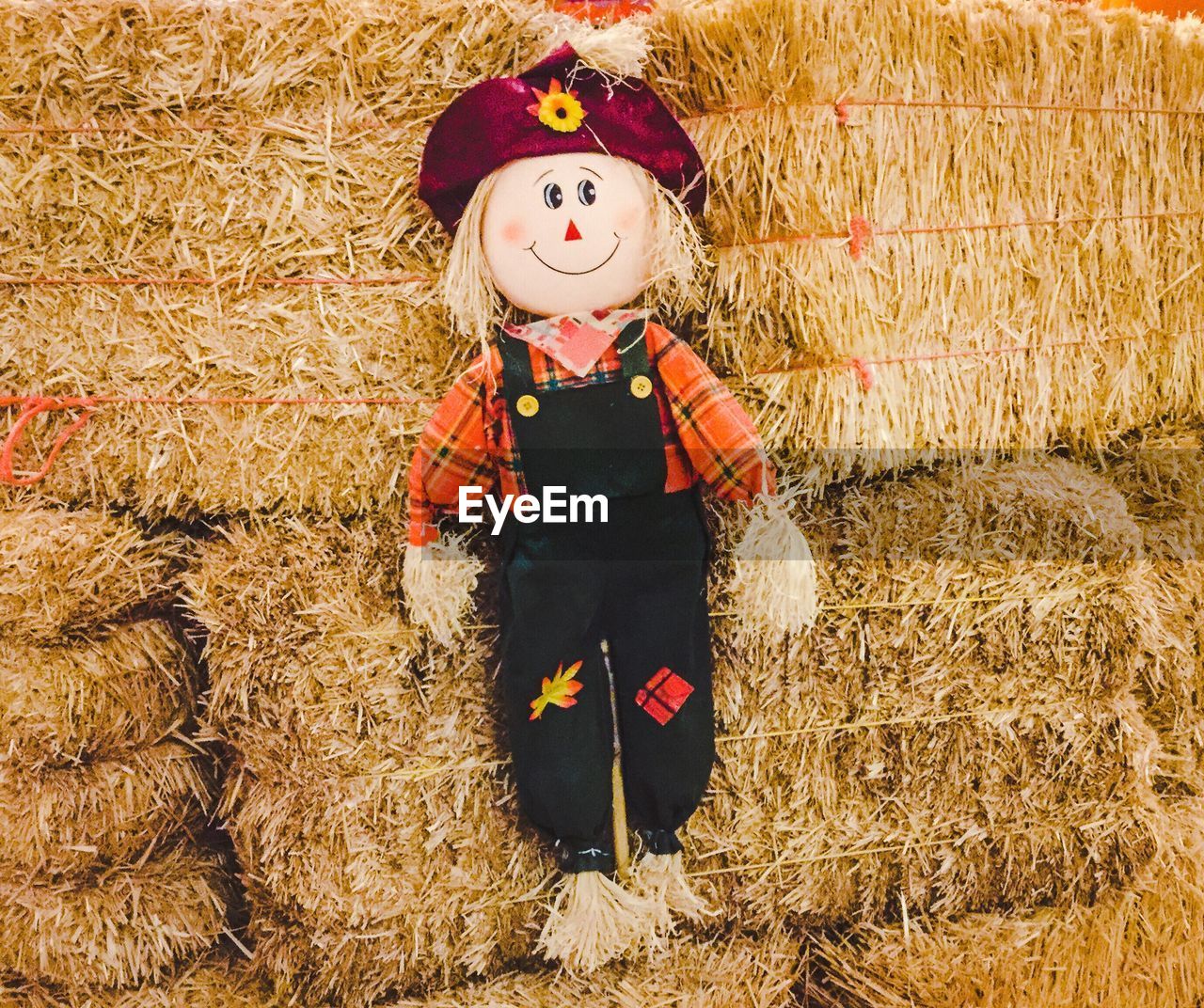 Toy hanging on hay bale at farm