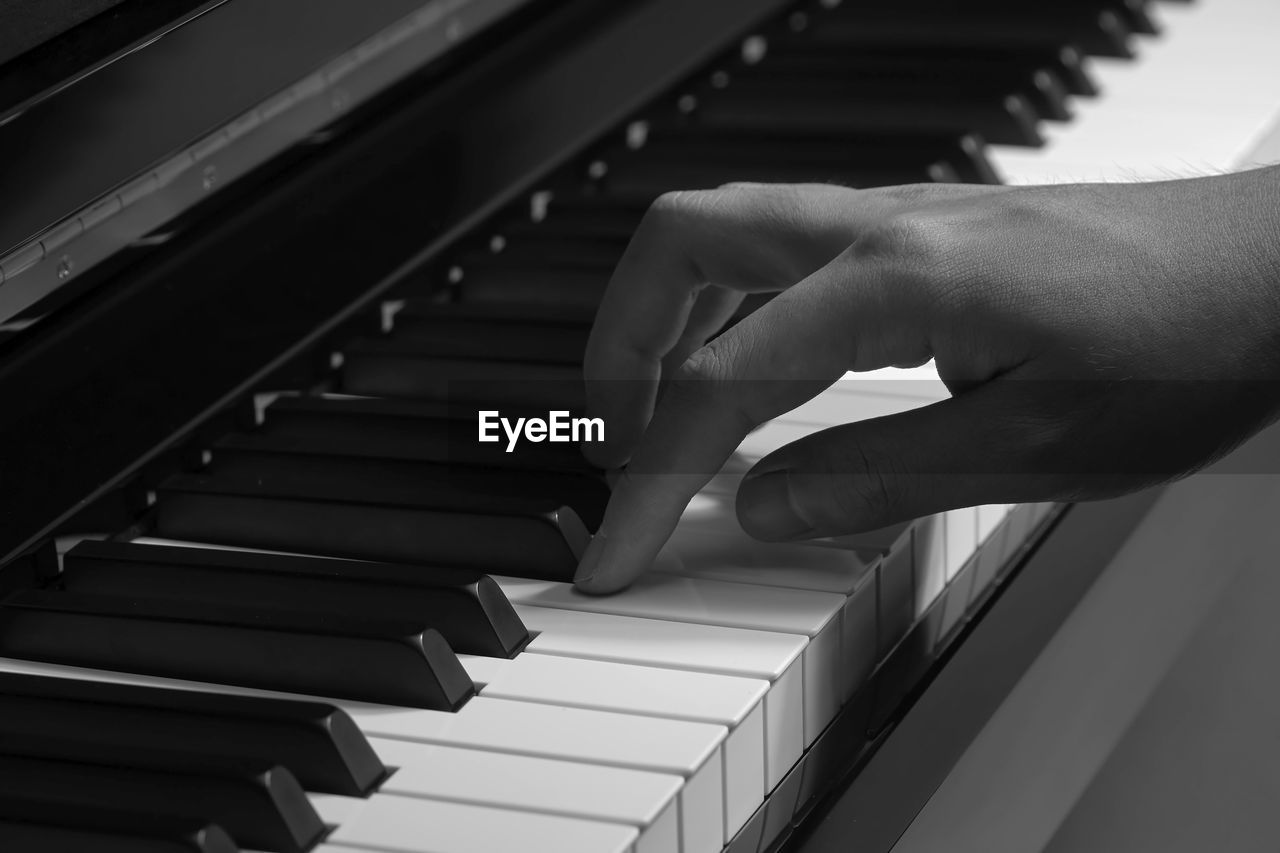 Close-up of man playing piano