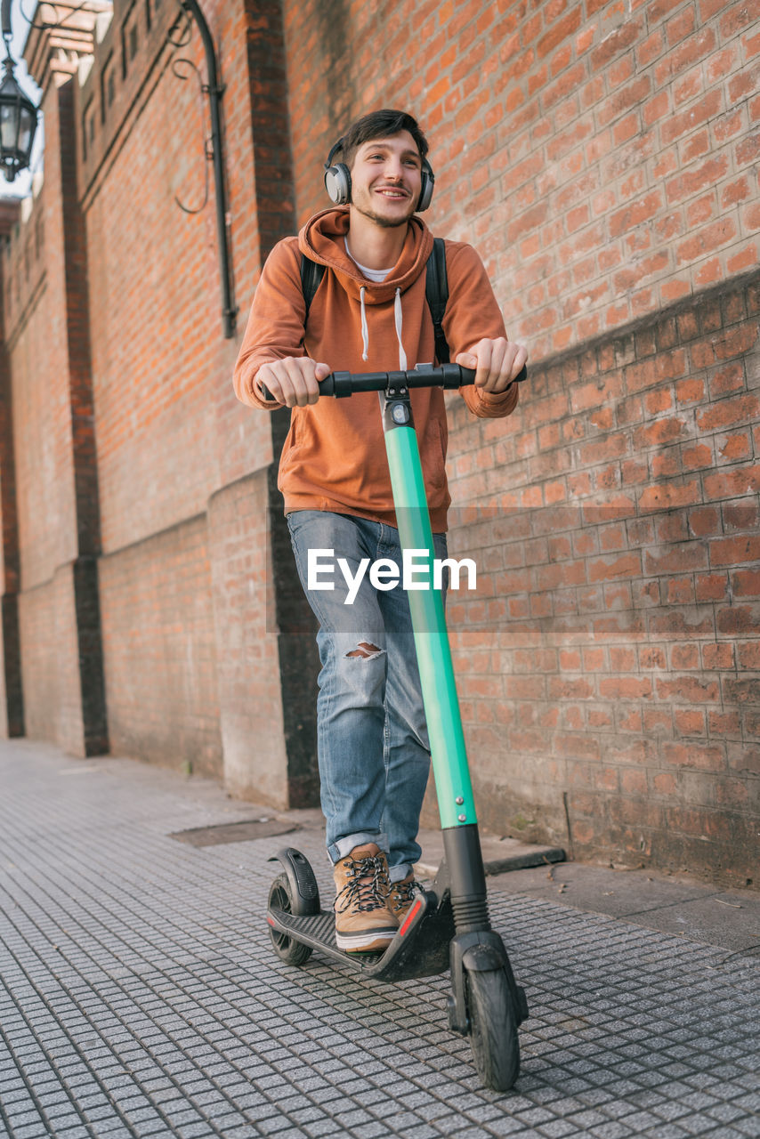 Smiling man on push scooter