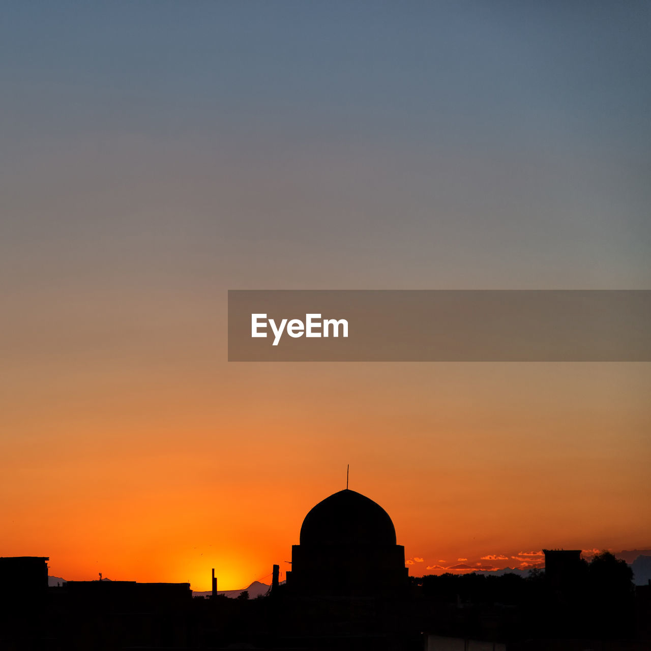 SILHOUETTE BUILDING AGAINST SKY AT SUNSET