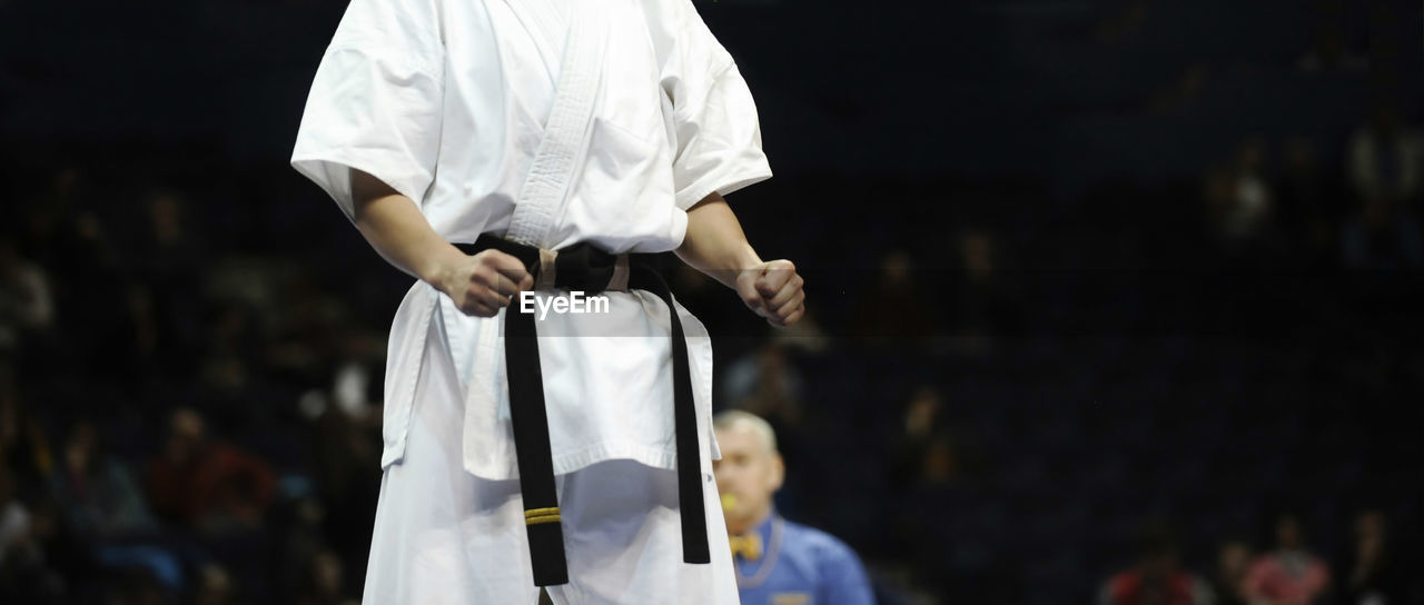 Midsection of boy wearing karate uniform