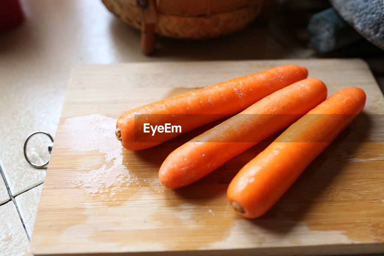 High angle view of carrots on cutting board