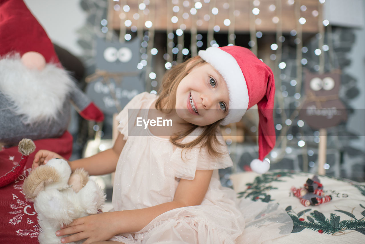 Close-up of girl playing under christmas tree