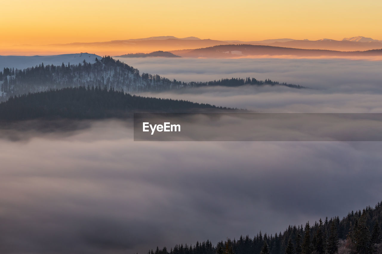 Scenic view of mountains against sky during sunset