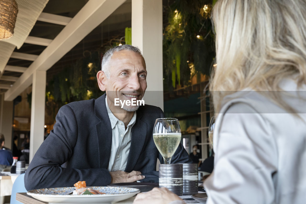 Romantic man looking at woman in restaurant
