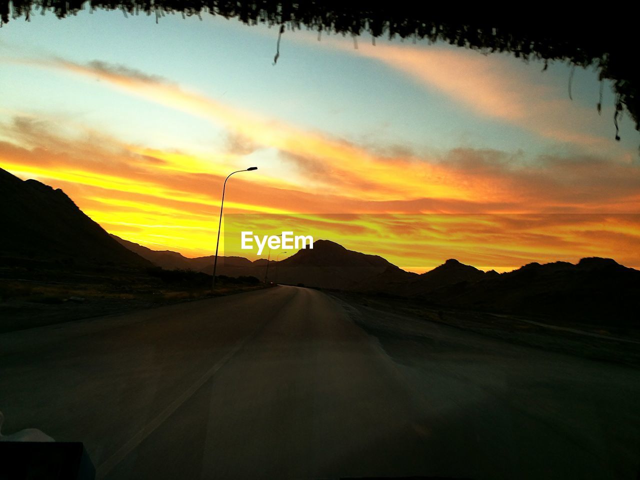 SCENIC VIEW OF SILHOUETTE ROAD AGAINST SKY DURING SUNSET