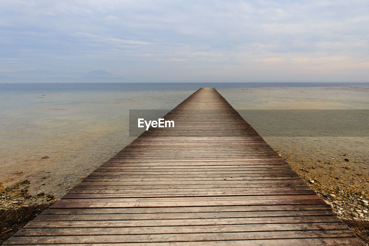 Pier over sea against sky