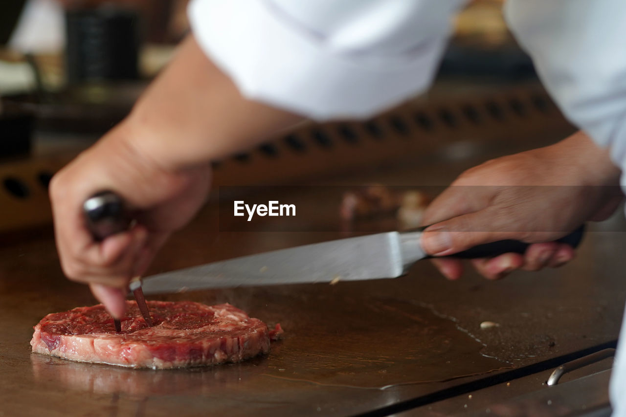 Midsection of man preparing food