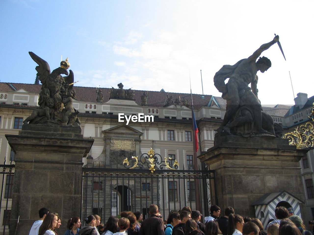 STATUE IN CITY AGAINST SKY