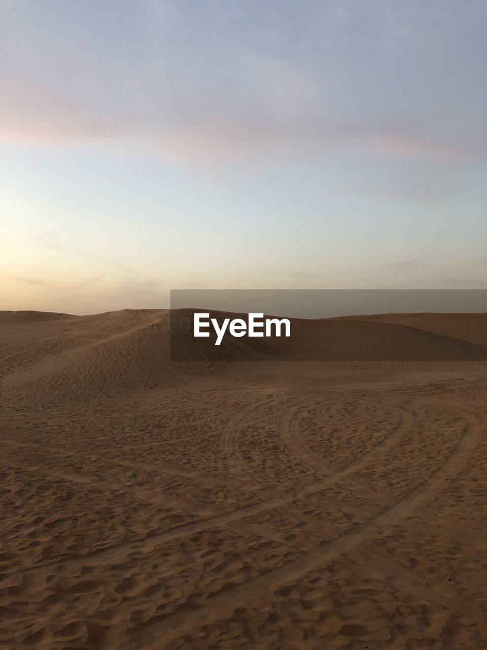 Scenic view of desert against sky during sunset