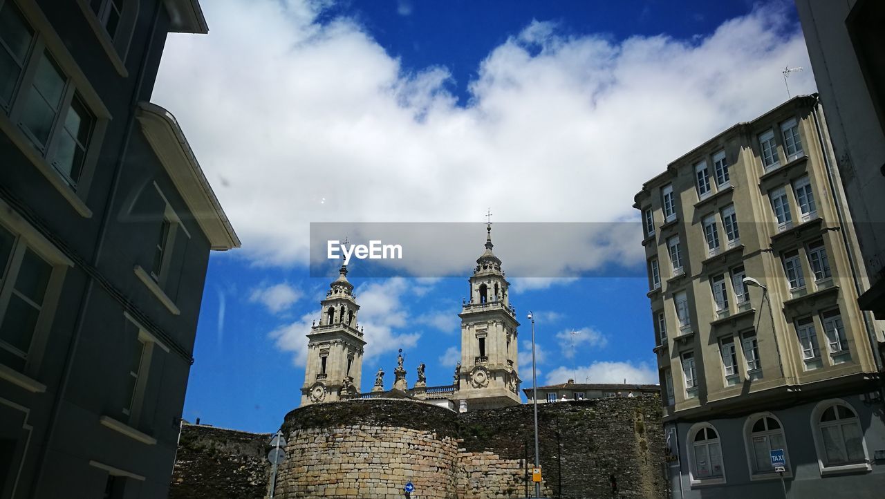 Low angle view of church against cloudy sky