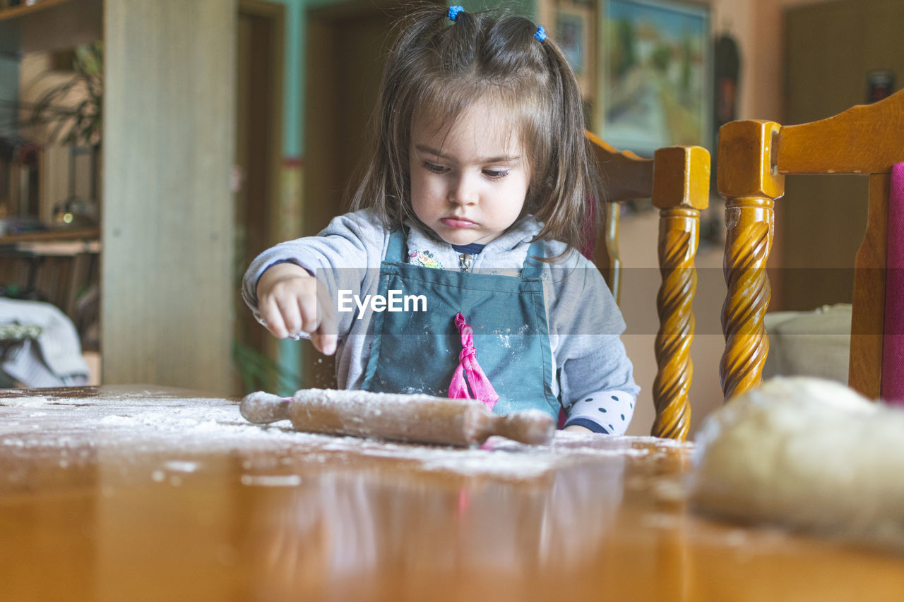 Cute girl making cookie at home