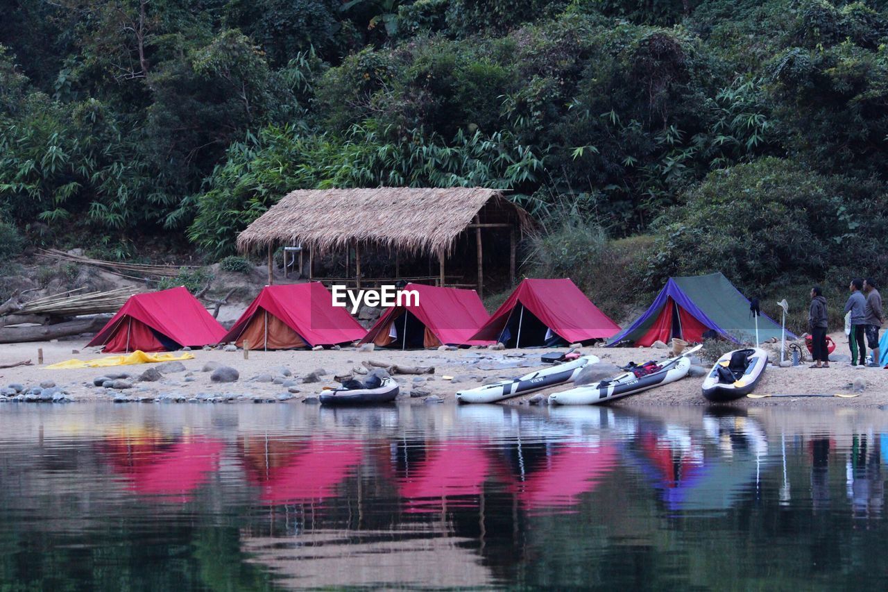 BUILT STRUCTURE IN LAKE AGAINST TREES