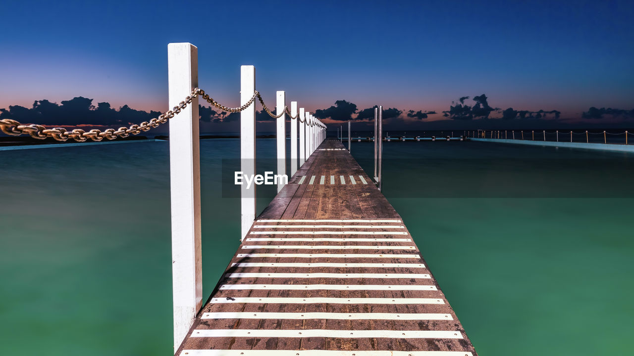 View of bridge over river against blue sky