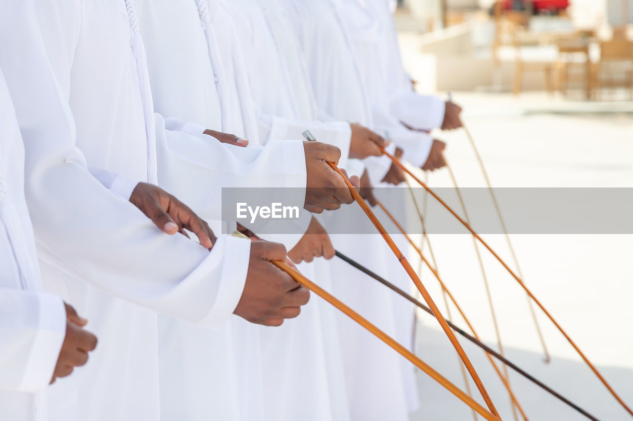 Traditional emirati al ayalah male dance, uae heritage, hands in frame
