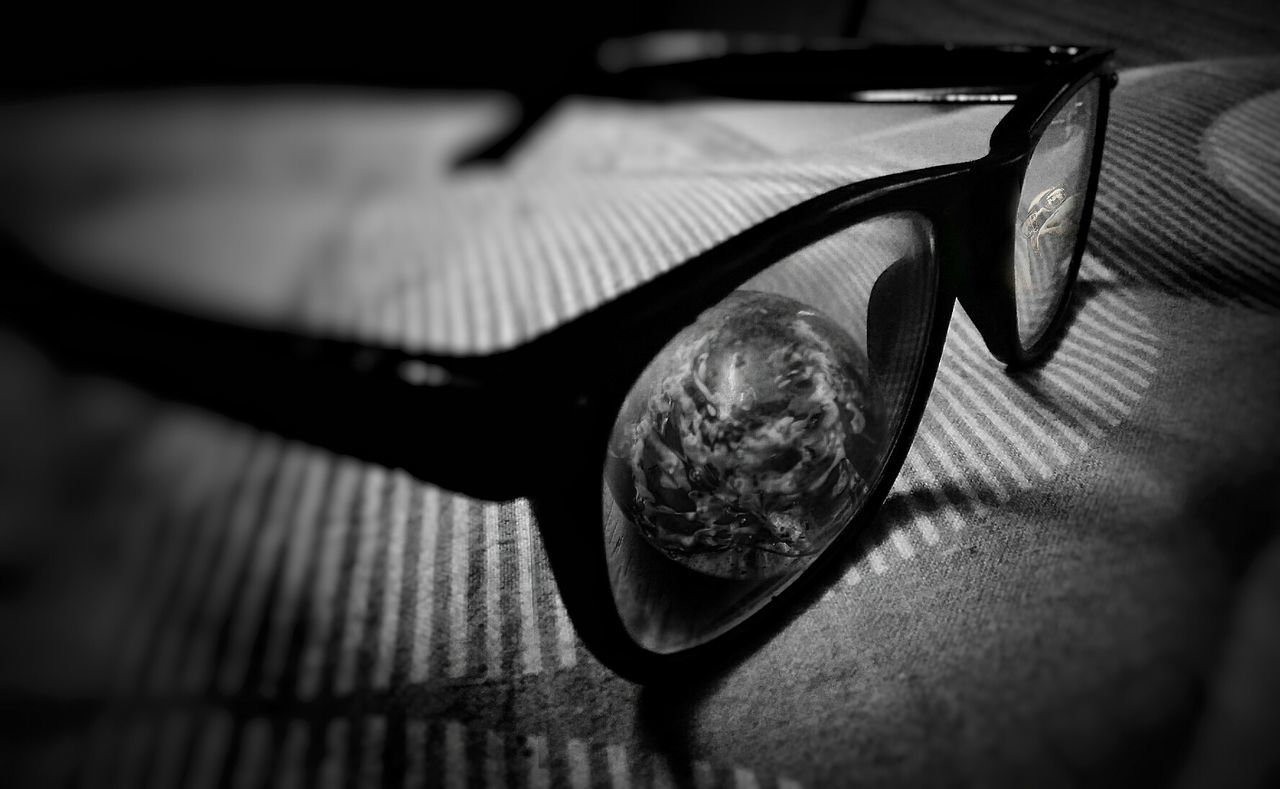 Close-up of eyeglasses and marble