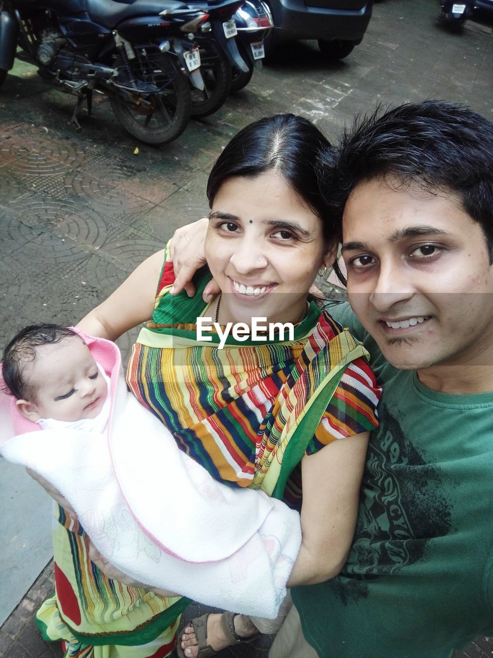 HIGH ANGLE PORTRAIT OF HAPPY YOUNG COUPLE