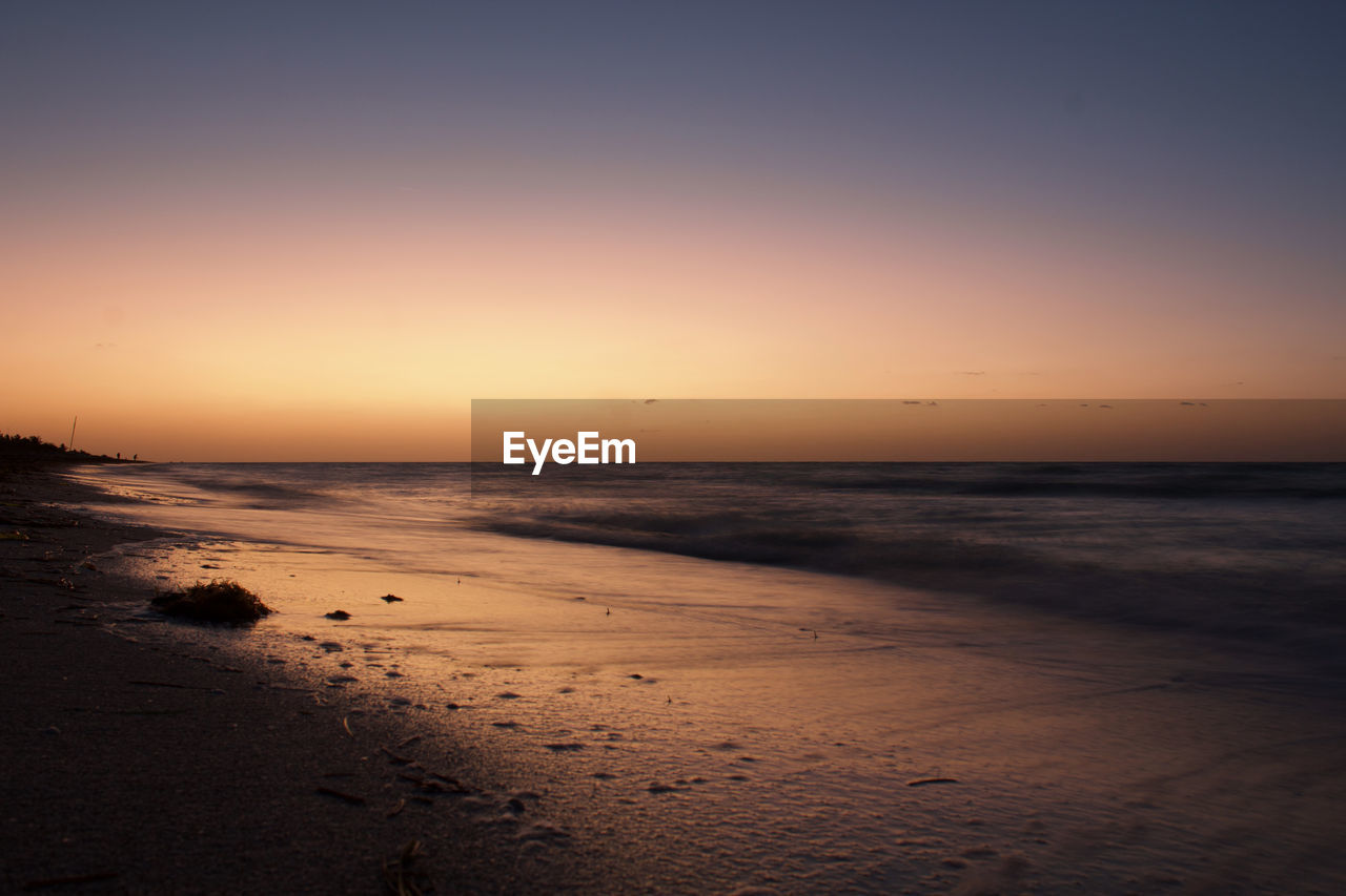 Scenic view of sea against clear sky during sunset