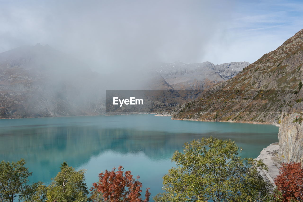 Scenic view of lake and mountains against sky