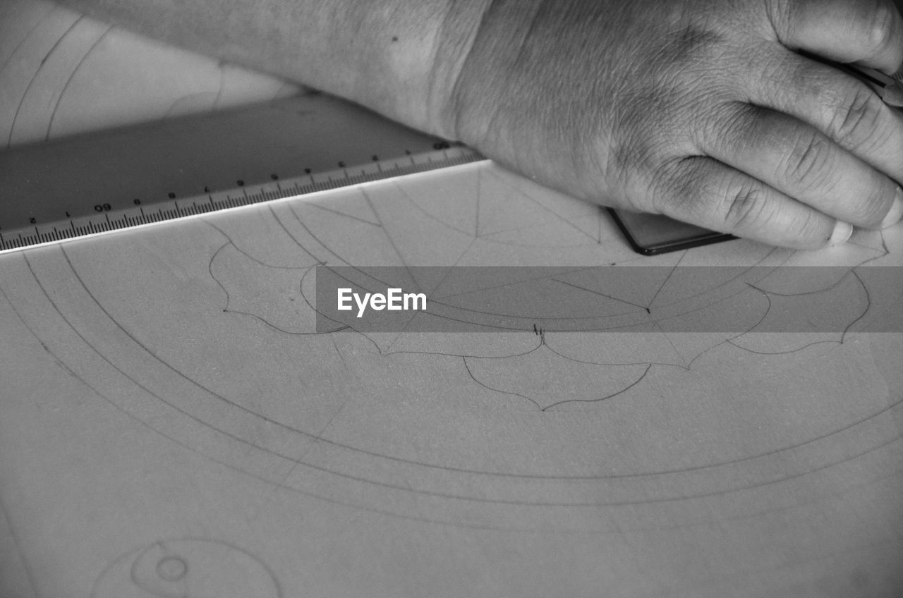 Close-up of architects hand drawing on paper