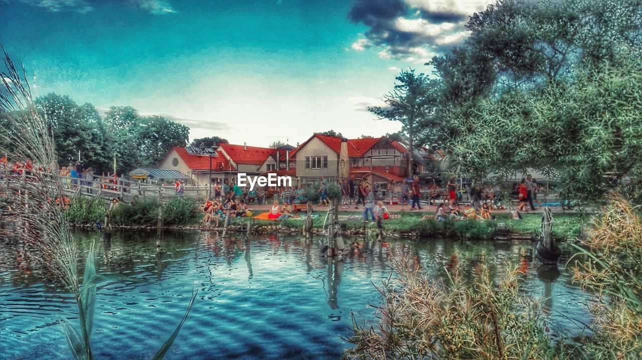 Calm lake with houses in background