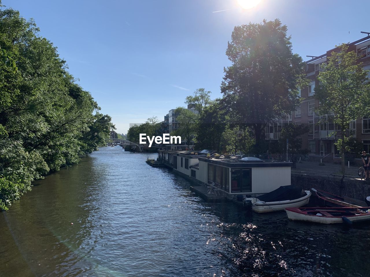 CANAL AMIDST CITY AGAINST SKY