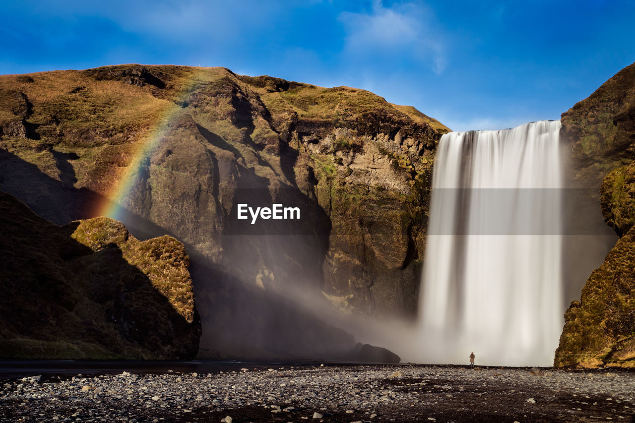 Scenic view of waterfall falling from mountain